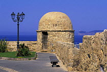 Torre di Castilla, part of the fortification in the old town of Alghero, Sardinia. In the background is the Capo Caccia promontory.