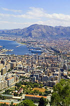 Port and town of Palermo, Sicily, Italy, with mountains in the distance.