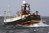 Fishing vessel in the North Sea heaving up warp wires in heavy swells. September 2005.