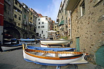 Small fishing on a waterside street in the tiny coastal town of Riomaggiore, situated in the Cinque Terre, Liguria, Italy.