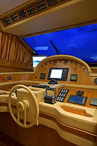 Cockpit and steering wheel of a Technema 65 motoryacht, built at the Rizzardi boatyard, at night in the Mediterranean, Italy.