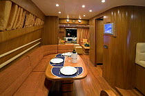 Seating and dining area, complete with flat screen television, on a Technema 65 motoryacht, built at the Rizzardi boatyard. Italy.