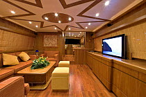 Luxurious seating and dining area, complete with flat screen television, of a luxurious Technema 65 motoryacht, built at the Rizzardi boatyard. Italy.