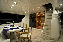 Outdoor seating and dining area on the rear lower deck of a Technema 65 motoryacht, built at the Rizzardi boatyard. Italy.