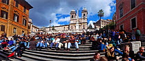 People sitting on the Spanish Steps (Scalinata di Spagna) in Rome. The steps lead to the French church, Trinità dei Monti. To the right is the house where John Keats died in 1821, now the Keats-Shell...