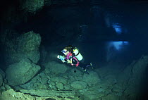 Diver exploring pure alabaster mineral, Alabaster Cave (La Grotta dell'Alabastro), Marina di Camerota, Campania, Italy.