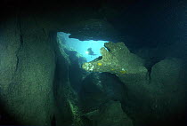 Diver exploring Alabaster Cave (La Grotta dell'Alabastro) in the dive centre of Marina di Camerota, Campania, Italy.