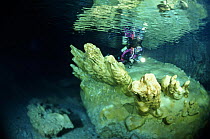 Diver exploring alabaster mineral deposits in Alabaster Cave (La Grotta dell'Alabastro) in the dive centre of Marina di Camerota, Campania, Italy.