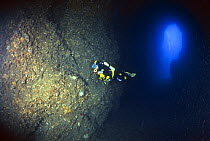 A scuba diver in the Azure Cave (Grotta Azzurra) in the diving centre of Marina di Camerota, Campania, Italy.