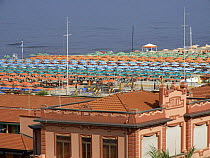 Sun beds, deckchairs and umbrellas line the sandy beach front of Viareggio at one of the famous "Bagni", Tuscany, Italy.