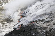 Lava flows into the Pacific Ocean off Volcanoes National Park, Big Island, Hawaii.