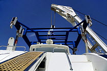 A lift holding an Alfamarine 47 luxury motoryacht in a sling, ready to launch her into the water. The superyacht was built at the Cantieri Alfamarine, Fiumicino, Lazio, Italy.