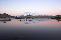 Loch na h'Achlaise on Rannoch Moor, with Black Mount reflecting in still water before dawn. Scotland, UK. February 2006.