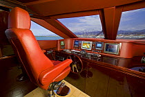 The red leather cockpit onboard Velvet 83', a luxurious motoryacht model from boatbuilders Cantieri Tecnomar, Viareggio, Italy.