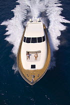 Velvet 83', a luxurious motoryacht model from boatbuilders Cantieri Tecnomar, with two women sunbating onboard, Viareggio, Italy.