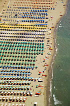Rows of colourful umbrellas and sun beds lining the beach resort of Viareggio, Tuscany, Italy. Tyrrhenian Sea, Mediterranean.