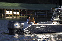 Couple relaxing on a Pursuit powerboat in Annapolis, Maryland, USA.