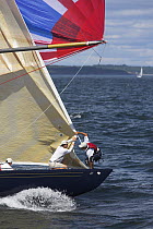 The crew on "Freedom" take down the head sail after the spinnaker is flying while racing in the 12 Metre World's Competition 2005, Newport, Rhode Island, USA.