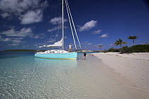 Shannon Shoalsailor moored up on a sandy beach. This innovative beachboat is a shallow draft boat designed to roam shallow waters such as these, Exuma, Bahamas.