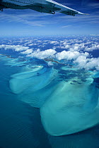 Aerial view with aeroplane wing and clouds, of Exuma, part of the chain of 365 islands that form the Bahamas.