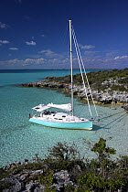 Shannon Shoalsailor moored alongside the shore. This innovative beachboat is a shallow draft boat designed to roam shallow waters such as these in Exuma, the Bahamas.