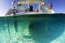 Split-level view of the hull of the Shannon Shoalsailor illustrating how this innovative, keelless, shallow draft beachboat is designed to roam shallow waters such as these in Exuma, the Bahamas.