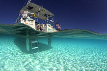 Split-level view of the hull of a Shannon Shoalsailor illustrating how this innovative, keelless, shallow draft beachboat is designed to roam shallow waters such as these in Exuma, the Bahamas. Model...