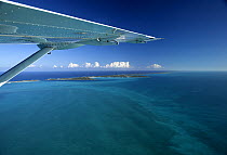 Aerial view of Exuma, with aeroplane wing, part of the chain of 365 islands that form the Bahamas.