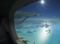 Aerial view through the window of a plane of the islands of Exuma, part of the chain of 365 islands that form the Bahamas.
