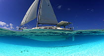 Split-level view of the hull of a Shannon Shoalsailor illustrating how this innovative, keelless, shallow draft beachboat is designed to roam shallow waters such as these in Exuma, the Bahamas. Proper...