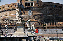 A view of the Castel Sant'Angelo and the angel statues on the Ponte Sant' Angelo (angel's bridge), Rome, Italy. ^^^The castle is also known as the Mausoleum of Hadrian as it was commissioned by the Ro...