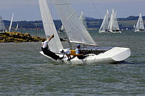 GBR1339 goes aground off Egypt Point to the west of Cowes, UK. A crew member leans out hanging off the leeward shroud to try to lever the keel off the mud during Skandia Cowes Week 2006, day 1 July 29...