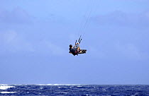 Kite surfer in the air during a trick.