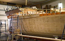 Wooden boat "Bystander" whilst being rebuilt. She was the original tender for the old J-Class yacht "Ranger", Newport, Rhode Island, USA.