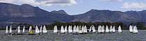 Small dinghies racing in a regatta during the Zeekoe Vlei Yacht Club (ZVYC) Races in Zeekoevlei, Cape Town, South Africa.