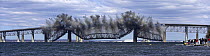 After simultanious explosions, the middle of the old Jamestown Bridge falls in to the water in Jamestown, Rhode Island, USA.