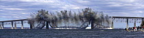 After simultanious explosions, the middle of the old Jamestown Bridge falls in to the water in Jamestown, Rhode Island, USA.