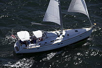 Aerial of a sailboat with reefed sails cruising in the waters off Newport, Rhode Island, USA.