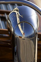The photographer's reflection captured in the shining metal onboard 140ft luxury schooner "Skylge", designed by André Hoek and built by Holland Jachtbouw, sailing in the French Riviera, France. Prope...