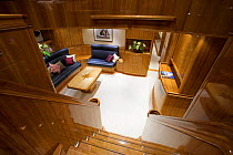 Looking down the staircase to the main saloon onboard 140ft luxury schooner "Skylge", designed by André Hoek and built by Holland Jachtbouw, sailing in the French Riviera, France. Property released.