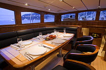 Table set up for dinner onboard 140ft luxury schooner "Skylge", designed by André Hoek and built by Holland Jachtbouw, sailing in the French Riviera, France. Property released.