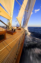 The bow of 140ft luxury schooner "Skylge" designed by André Hoek and built by Holland Jachtbouw, crashing into a wave while sailing on the leeward rail, French Riviera, France. Property released.