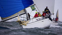 During a race downwind under spinnaker, with grey skies during the Onion Patch Series 2006 in Newport, Rhode Island, USA.