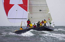 During a race downwind with spinnaker under grey skies during the Onion Patch Series races in Newport, Rhode Island, USA.