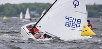 Dinghy capsizing while rounding the mark during the Optimist regatta, Newport, Rhode Island, USA.