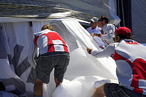 Maximus crew working together to take down a sail during the 2006 Newport to Bermuda race.