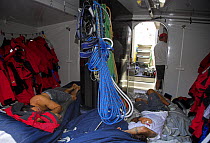 Crew sleeping among the sails and supplies on board "Maximus" during the 2006 Newport to Bermuda race.