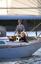 Two people on board a Morris 42 cruising in the evening, Newport, Rhode Island, USA.