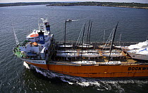 Yacht transport ship loaded up and leaving port, Newport, Rhode Island, USA.