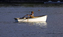 Child in a rowing tender, Rhode Island.